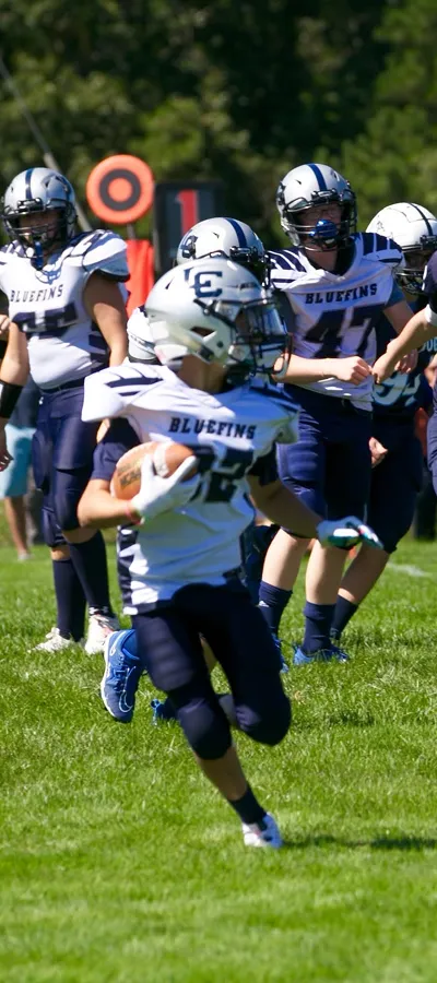 A Bluefins player carrying the ball upfield